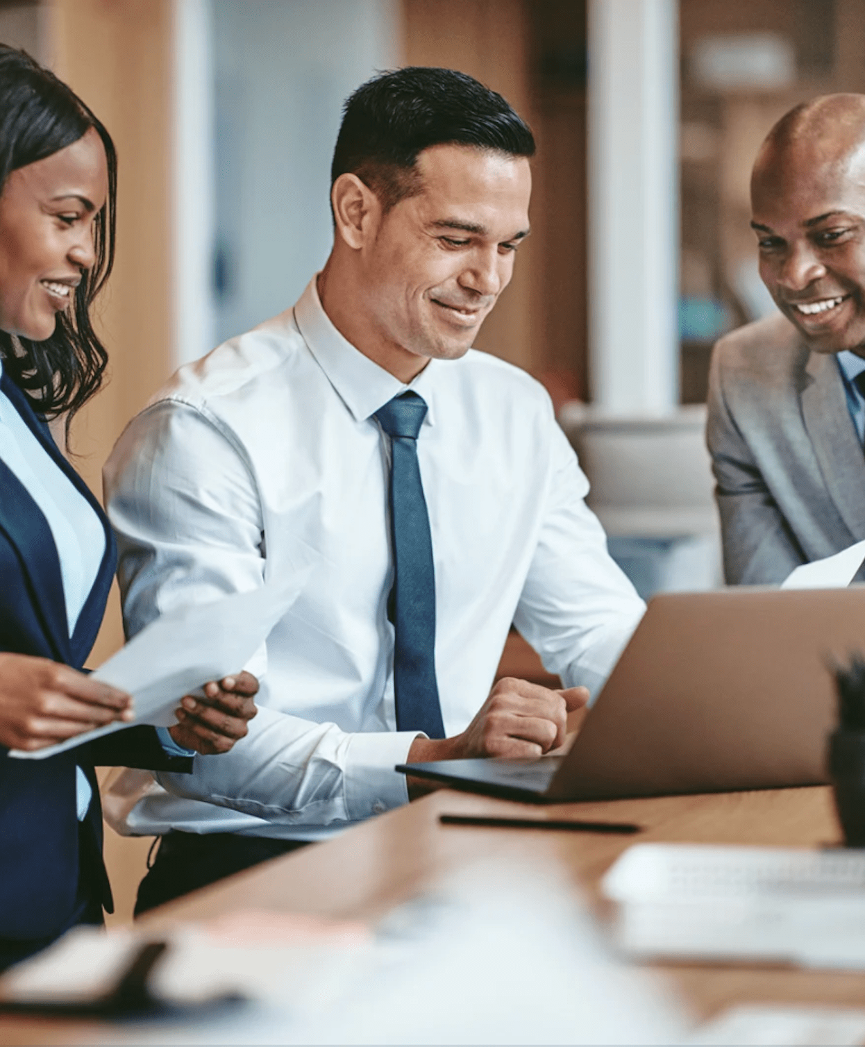 coworkers looking at computer smiling